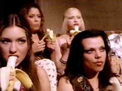 Some girls eating fresh bananas.